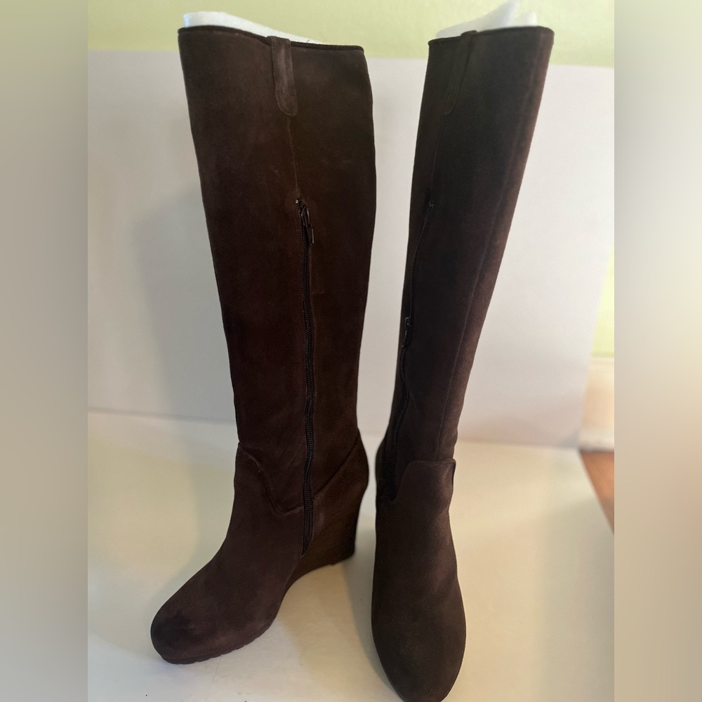 Tall brown suede boots with a wedge heel